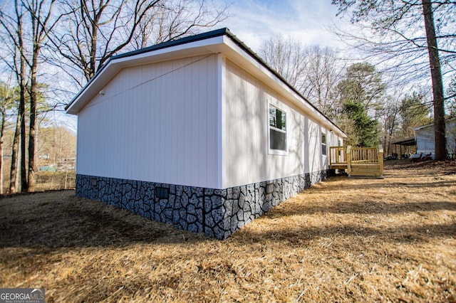 view of side of home with a wooden deck