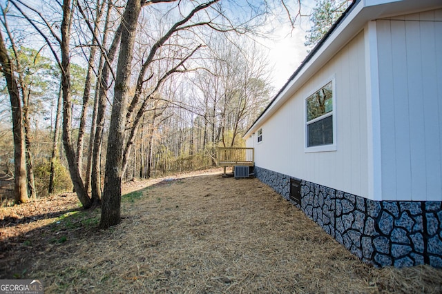 view of yard with cooling unit and a wooden deck