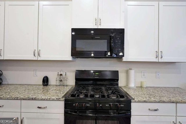 kitchen with white cabinetry and black appliances