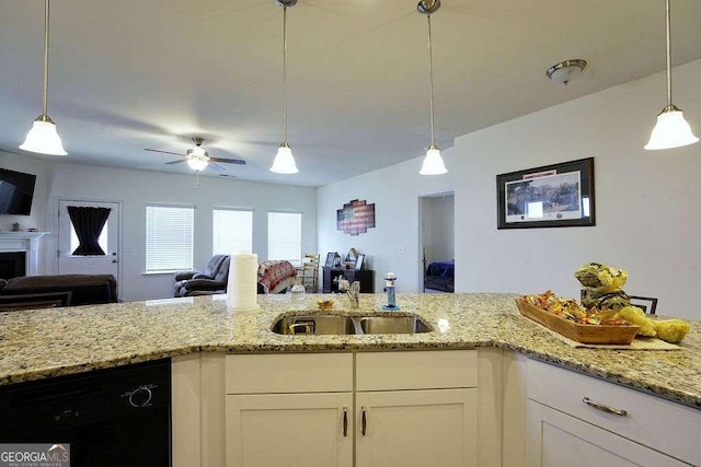 kitchen with hanging light fixtures, white cabinetry, black dishwasher, and sink