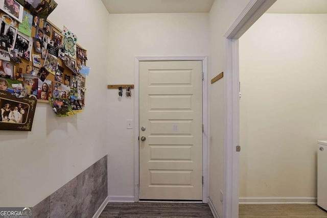 doorway to outside with dark hardwood / wood-style floors and washer / clothes dryer