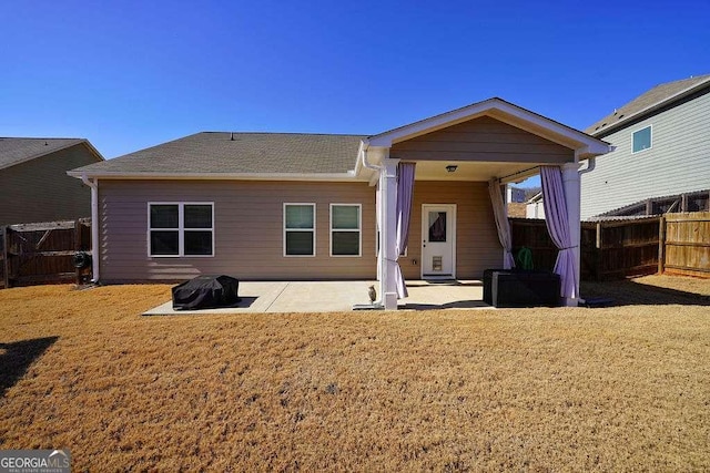 rear view of house featuring a patio area and a lawn