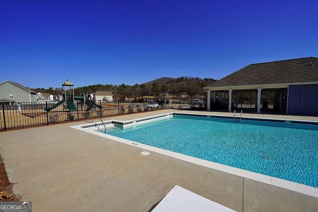 view of pool with a playground