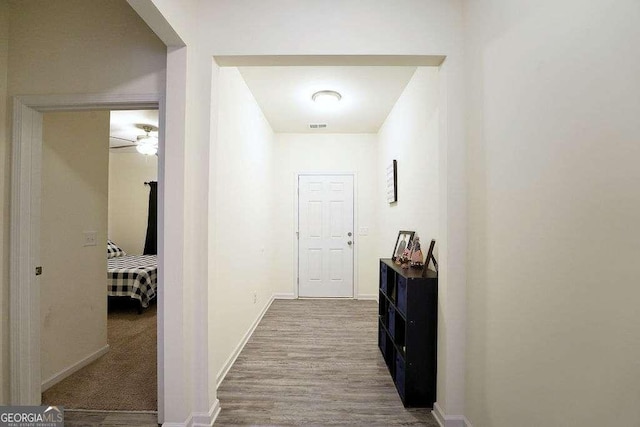 hall with hardwood / wood-style floors