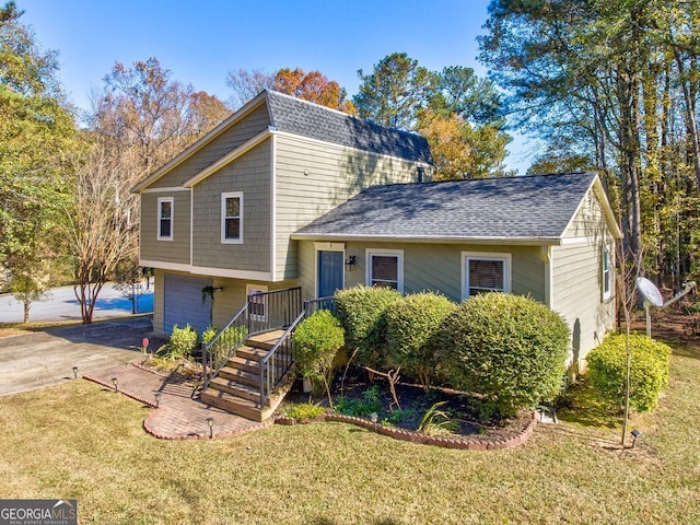 split level home with a garage and a front yard