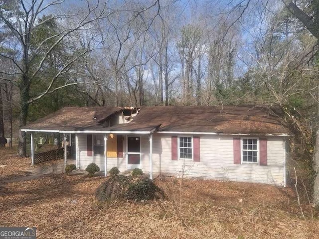 ranch-style house with a carport and covered porch