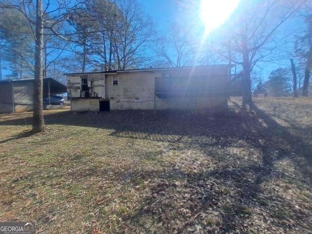 back of property featuring a yard