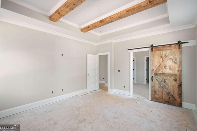 unfurnished room featuring beam ceiling, ornamental molding, and a barn door