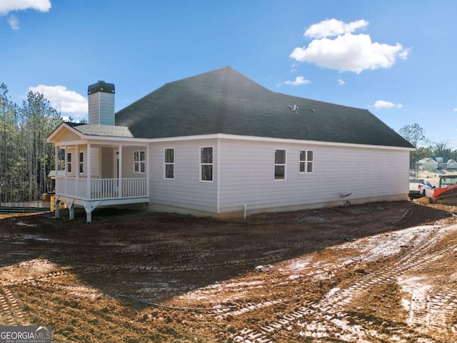 back of house featuring a porch