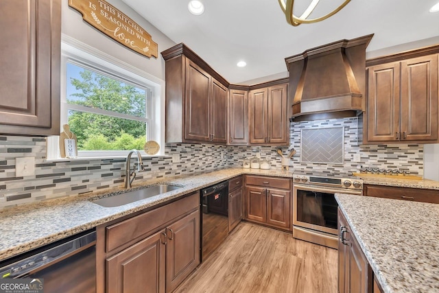 kitchen featuring stainless steel electric range oven, dishwasher, sink, and custom exhaust hood