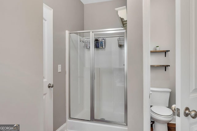 bathroom featuring toilet and walk in shower