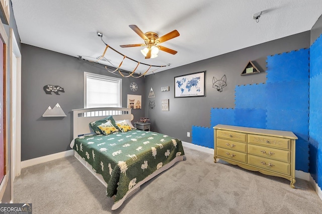 bedroom with ceiling fan and light colored carpet