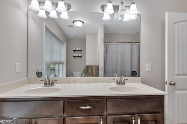 bathroom with vanity, curtained shower, and toilet