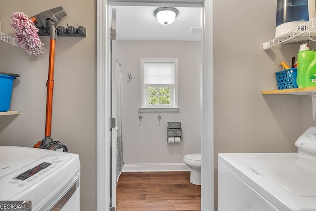 clothes washing area featuring hardwood / wood-style flooring and independent washer and dryer