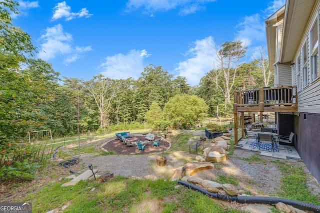 view of yard with a wooden deck and a patio area