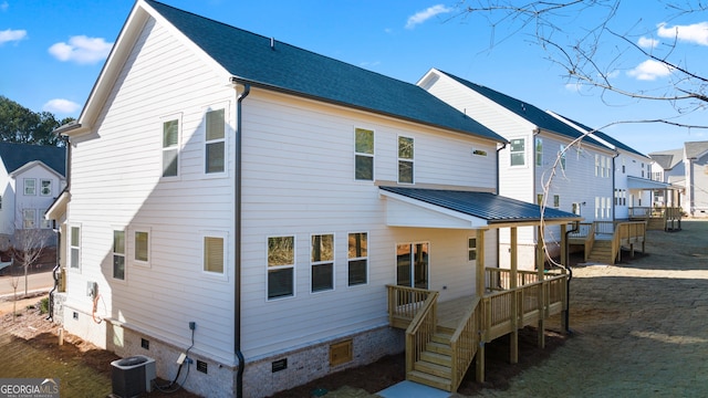 back of property featuring central AC and a deck