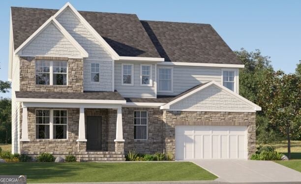 view of front of house with a garage and a front yard