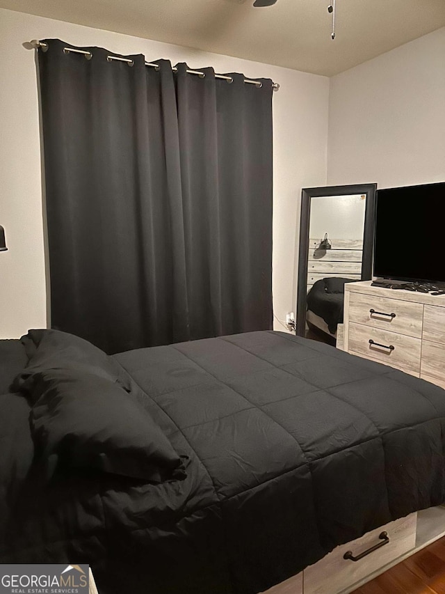 bedroom with wood-type flooring