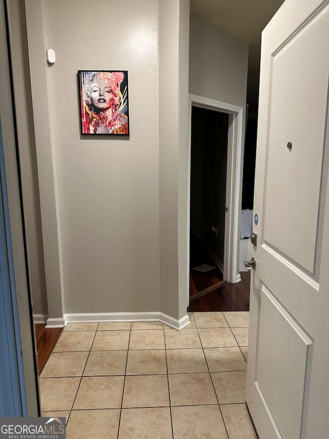 hall featuring light tile patterned flooring