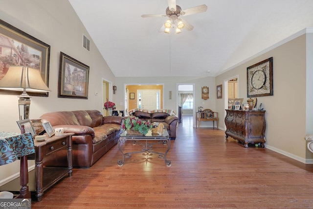 living room featuring hardwood / wood-style flooring, ceiling fan, and high vaulted ceiling