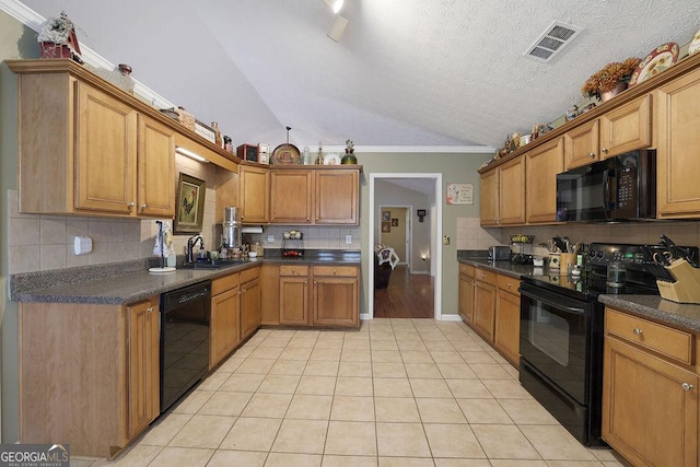 kitchen with lofted ceiling, sink, tasteful backsplash, light tile patterned floors, and black appliances