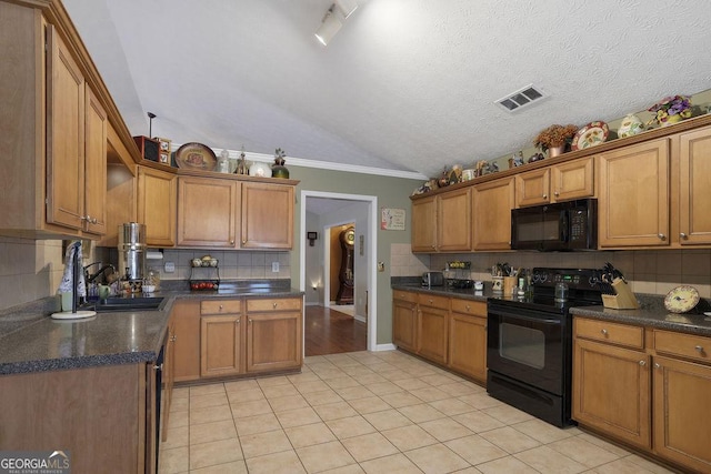 kitchen with sink, vaulted ceiling, light tile patterned floors, decorative backsplash, and black appliances