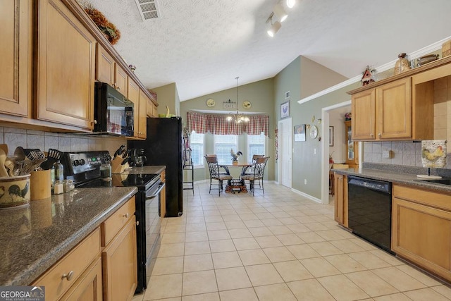 kitchen featuring lofted ceiling, dark stone countertops, light tile patterned floors, pendant lighting, and black appliances