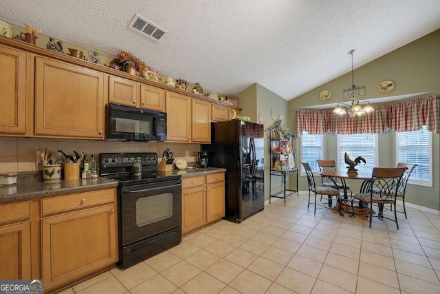 kitchen featuring pendant lighting, an inviting chandelier, black appliances, light tile patterned flooring, and vaulted ceiling