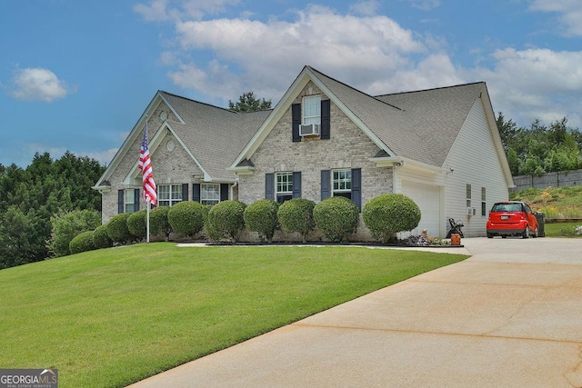 view of front of house featuring cooling unit, a garage, and a front lawn