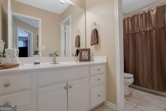 bathroom featuring vanity, toilet, and tile patterned flooring