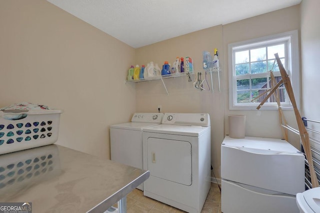 laundry area featuring washer and dryer and light tile patterned floors