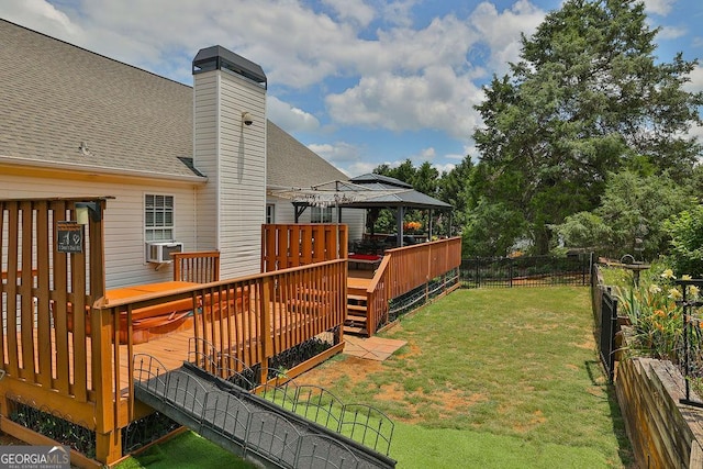 wooden terrace with a gazebo and a lawn