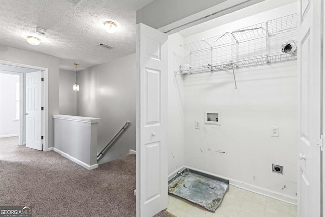 laundry room with electric dryer hookup, hookup for a washing machine, carpet floors, and a textured ceiling