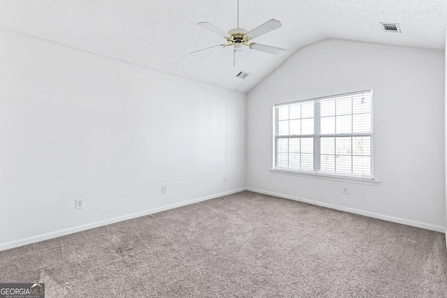 spare room with lofted ceiling, a textured ceiling, ceiling fan, and carpet flooring