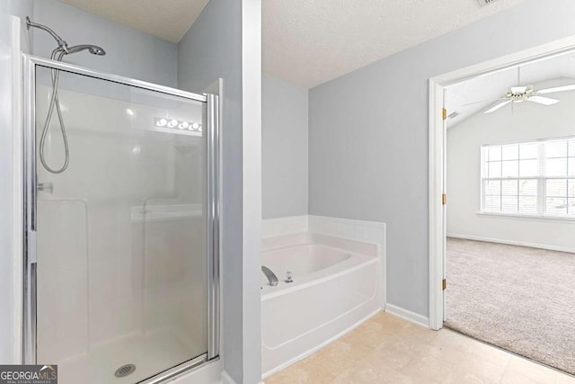 bathroom featuring plus walk in shower, vaulted ceiling, ceiling fan, and a textured ceiling