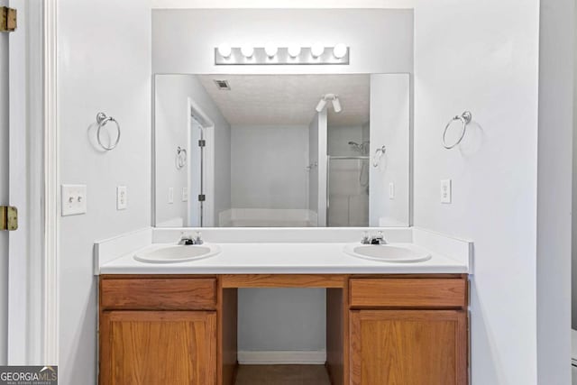 bathroom with vanity and a shower with door