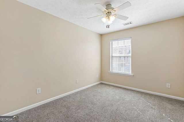 empty room with carpet floors, a textured ceiling, and ceiling fan