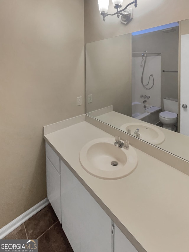 full bathroom with tile patterned flooring, shower / bathing tub combination, vanity, a notable chandelier, and toilet