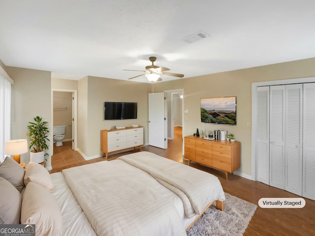 bedroom featuring ceiling fan, connected bathroom, and a closet