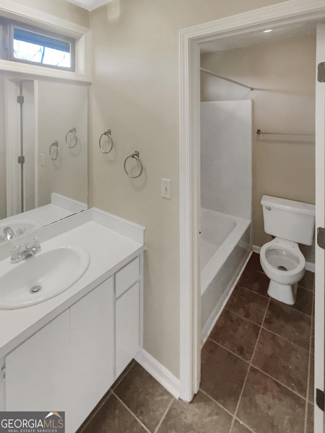 bathroom with vanity, tile patterned floors, and toilet