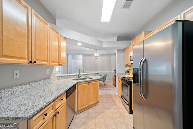 kitchen with sink, light stone counters, kitchen peninsula, stainless steel appliances, and light brown cabinets