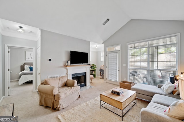 living room featuring lofted ceiling and light colored carpet