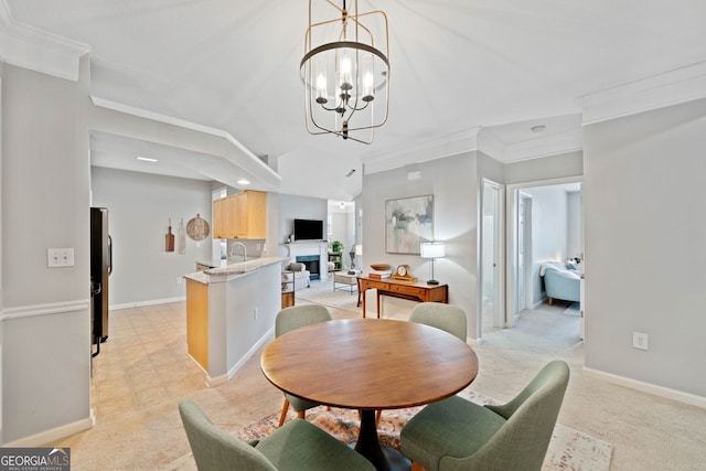 carpeted dining room featuring ornamental molding and a notable chandelier