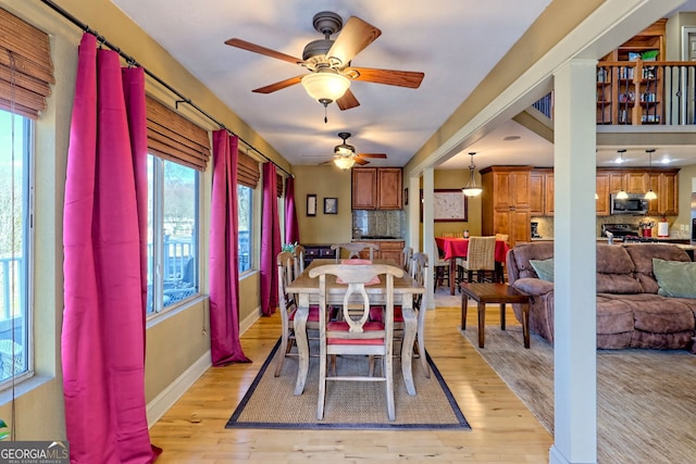 dining area featuring ceiling fan and light wood-type flooring