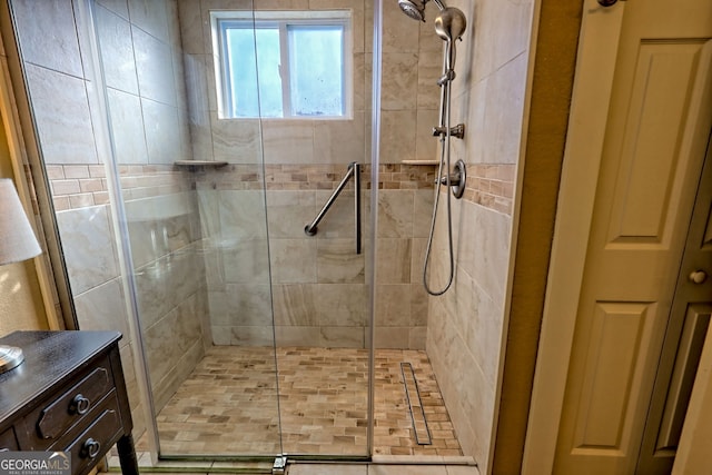 bathroom featuring a shower with door