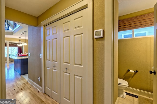 hall with a chandelier and light hardwood / wood-style flooring