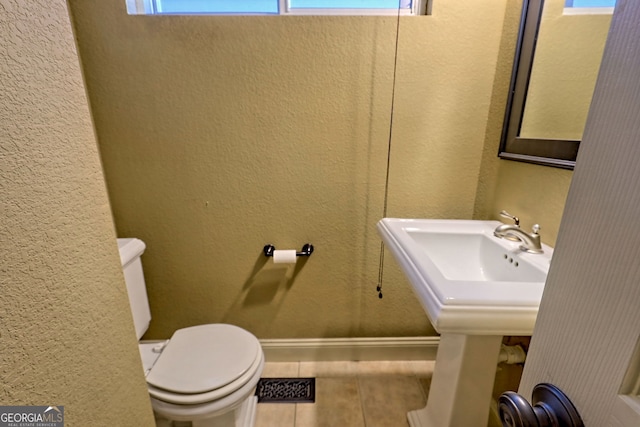 bathroom with tile patterned floors and toilet