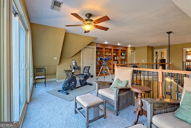 sitting room featuring light colored carpet and ceiling fan