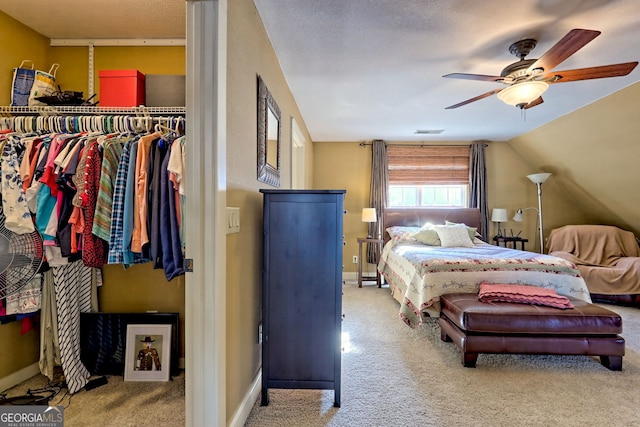 carpeted bedroom with lofted ceiling and ceiling fan