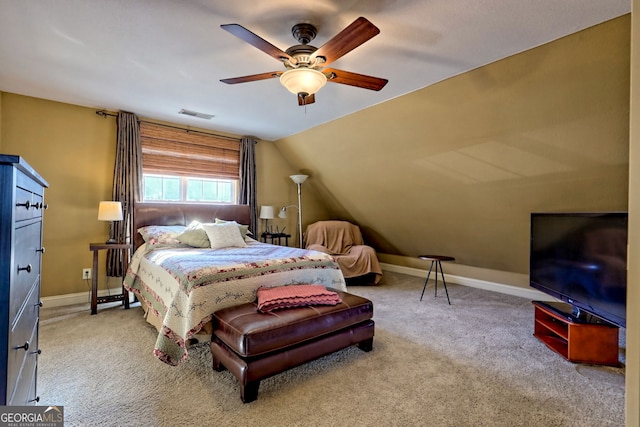 carpeted bedroom with vaulted ceiling and ceiling fan